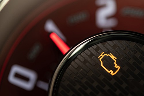Blinking orange check engine light on a vehicle dashboard. Concept image of “Why is My Check Engine Light On?” | Modern Auto Service in Fruitland, ID.