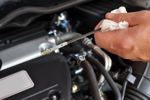 Featuring the owner of the car checking the oil level | Car Fluid Maintenance in Fruitland